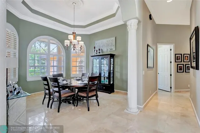 a kitchen with stainless steel appliances kitchen island granite countertop a refrigerator a stove and a sink with wooden floor