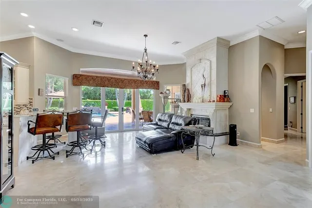 a view of a dining room with furniture and chandelier
