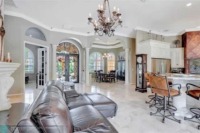 a bedroom with a large bed and a chandelier