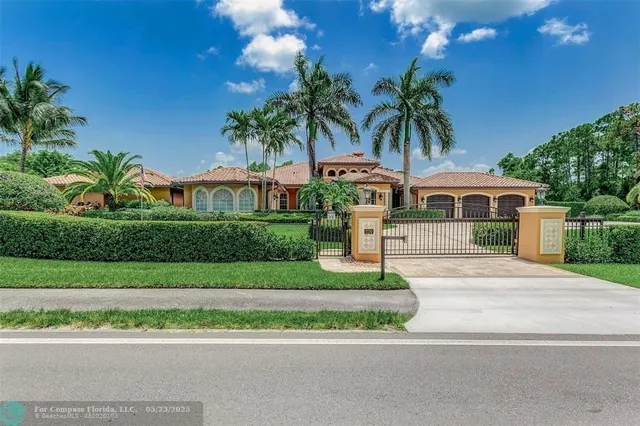 a front view of a house with a garden and plants