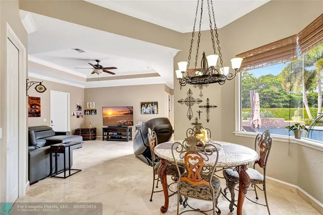 a living room with patio furniture and a flat screen tv