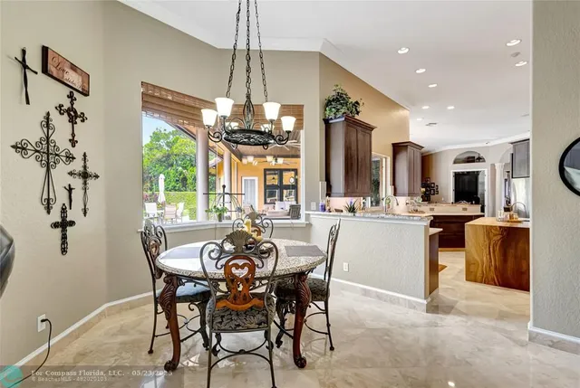 a view of a patio with a table and chairs and potted plants