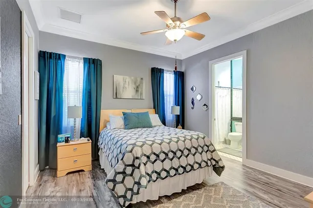a view of a patio with table and chairs potted plants and palm tree