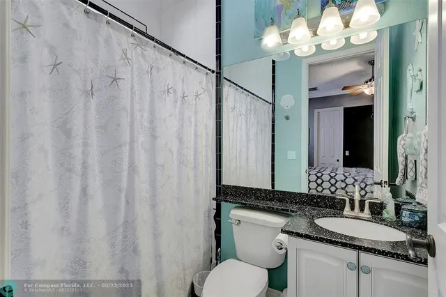 a view of a backyard with potted plants and large trees
