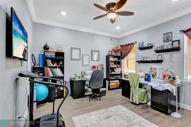 a kitchen with stainless steel appliances granite countertop a dining table chairs wooden cabinets and a refrigerator