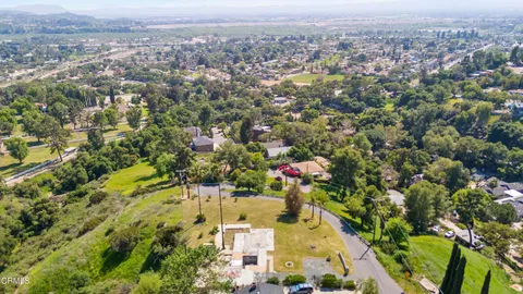an aerial view of residential house with green space