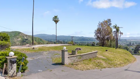 a view of a swimming pool with a yard and a sitting area