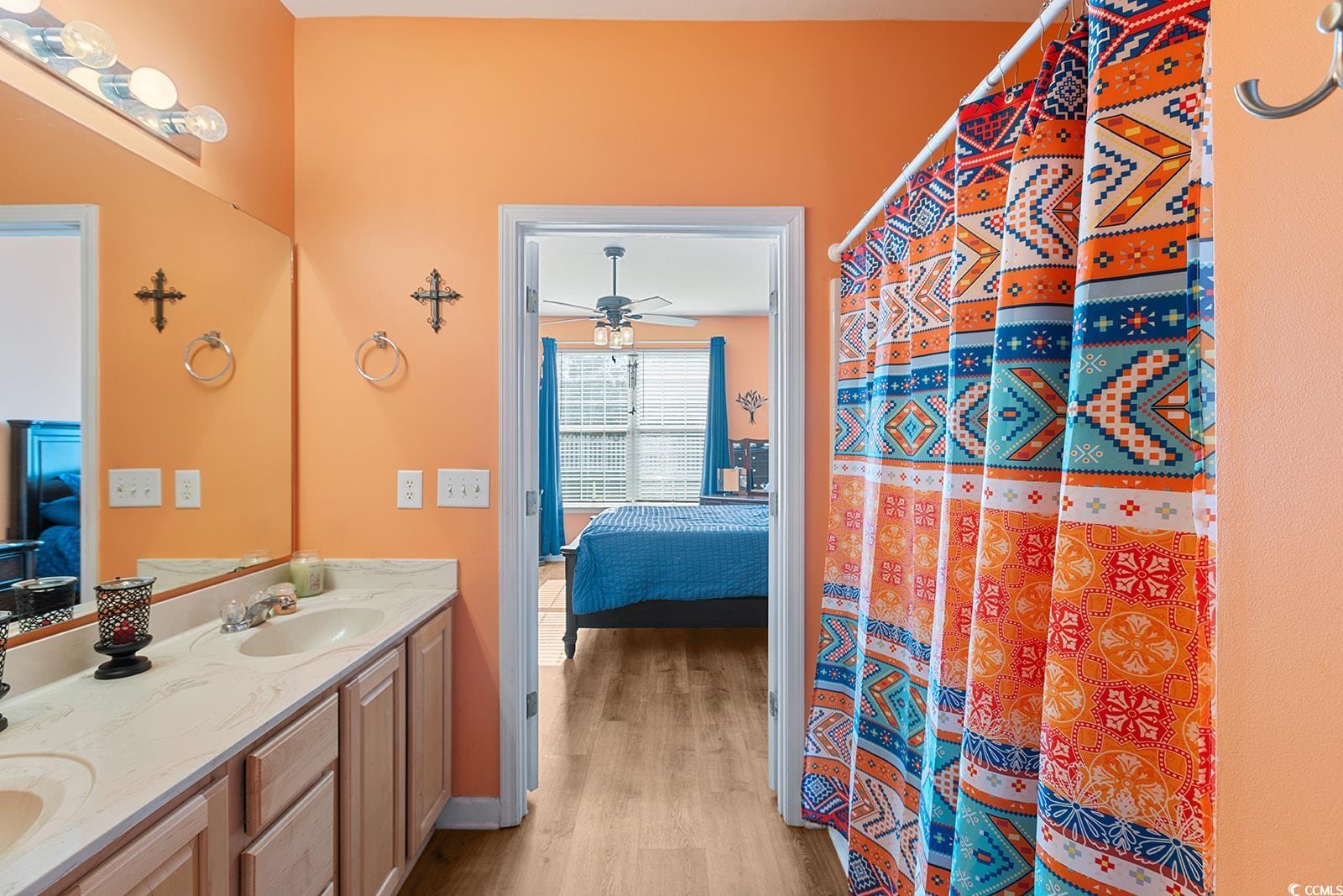 720 Gazania Lane Myrtle Beach, SC 29579 - Photo 17 of 32 Ensuite bathroom featuring double vanity, a shower with curtain, light wood-style flooring, and ceiling fan