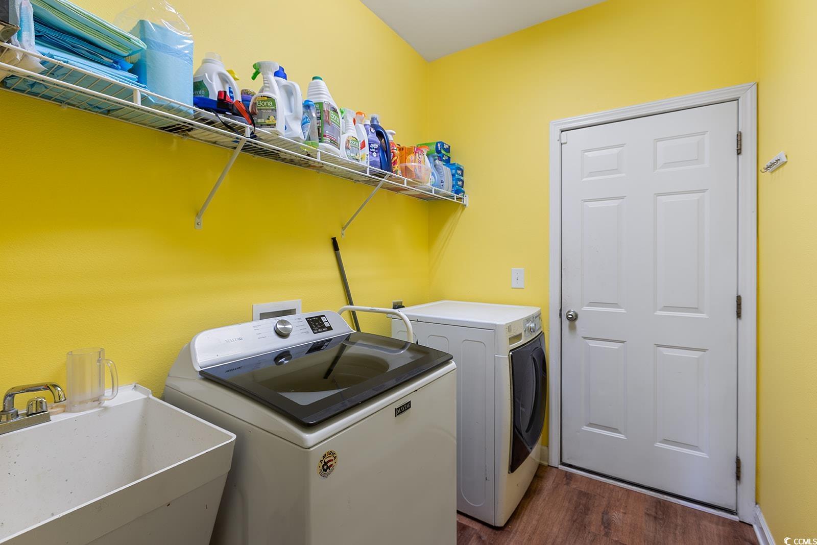 720 Gazania Lane Myrtle Beach, SC 29579 - Photo 18 of 32 Laundry area with dark wood finished floors and washer and clothes dryer