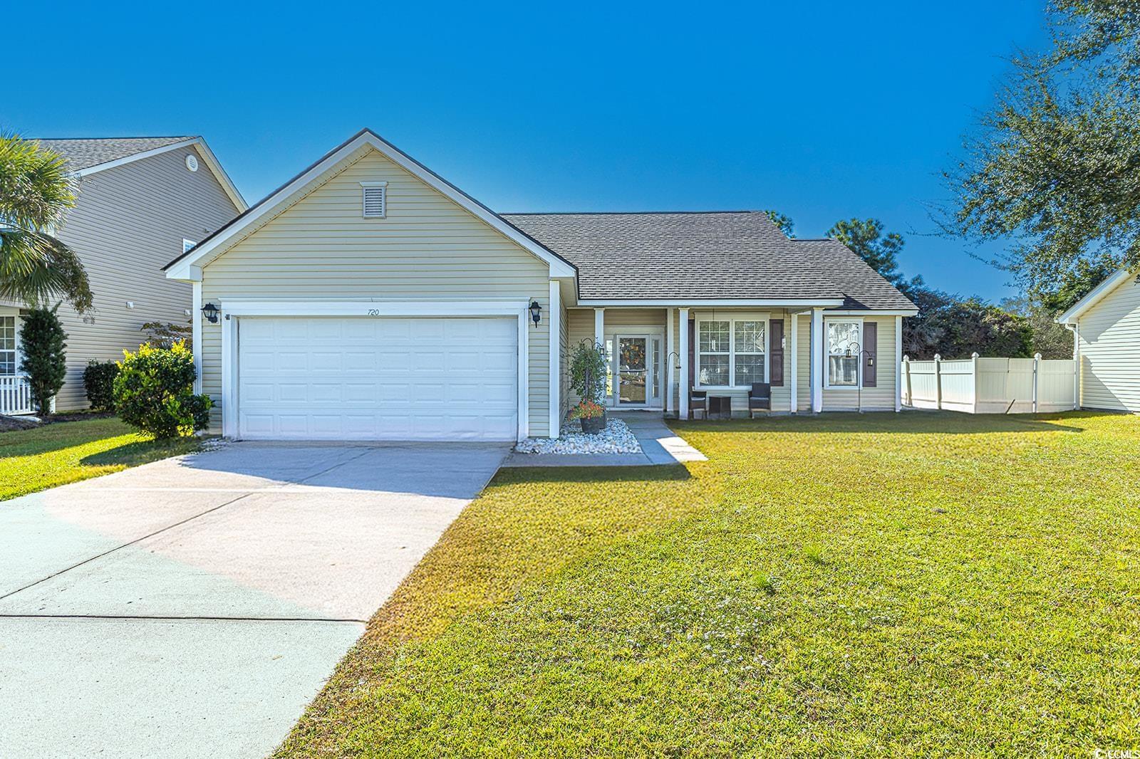 720 Gazania Lane Myrtle Beach, SC 29579 - Photo 2 of 32 View of front of property with roof with shingles, concrete driveway, covered porch, and a garage