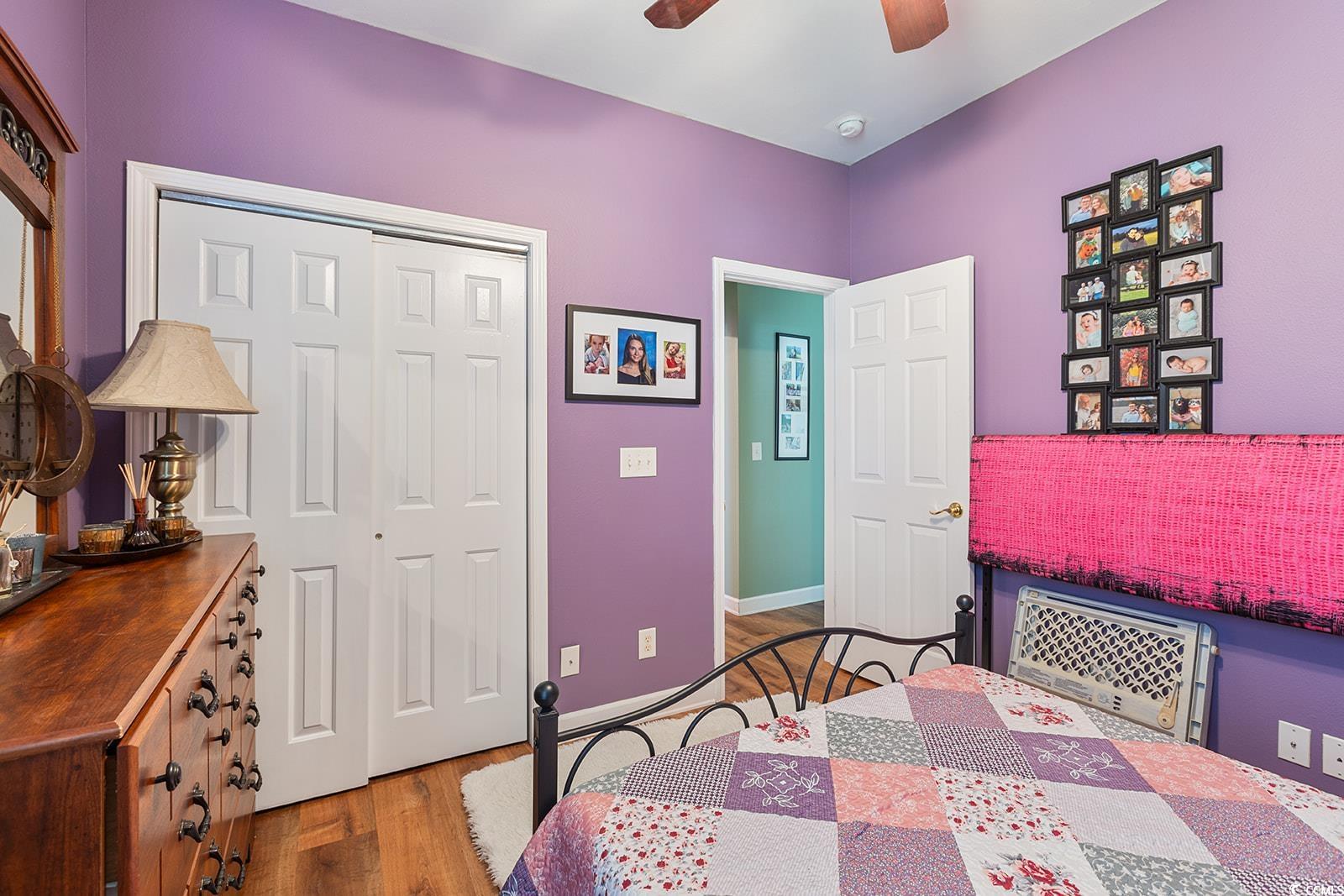 720 Gazania Lane Myrtle Beach, SC 29579 - Photo 22 of 32 Bedroom featuring wood finished floors, a closet, and a ceiling fan