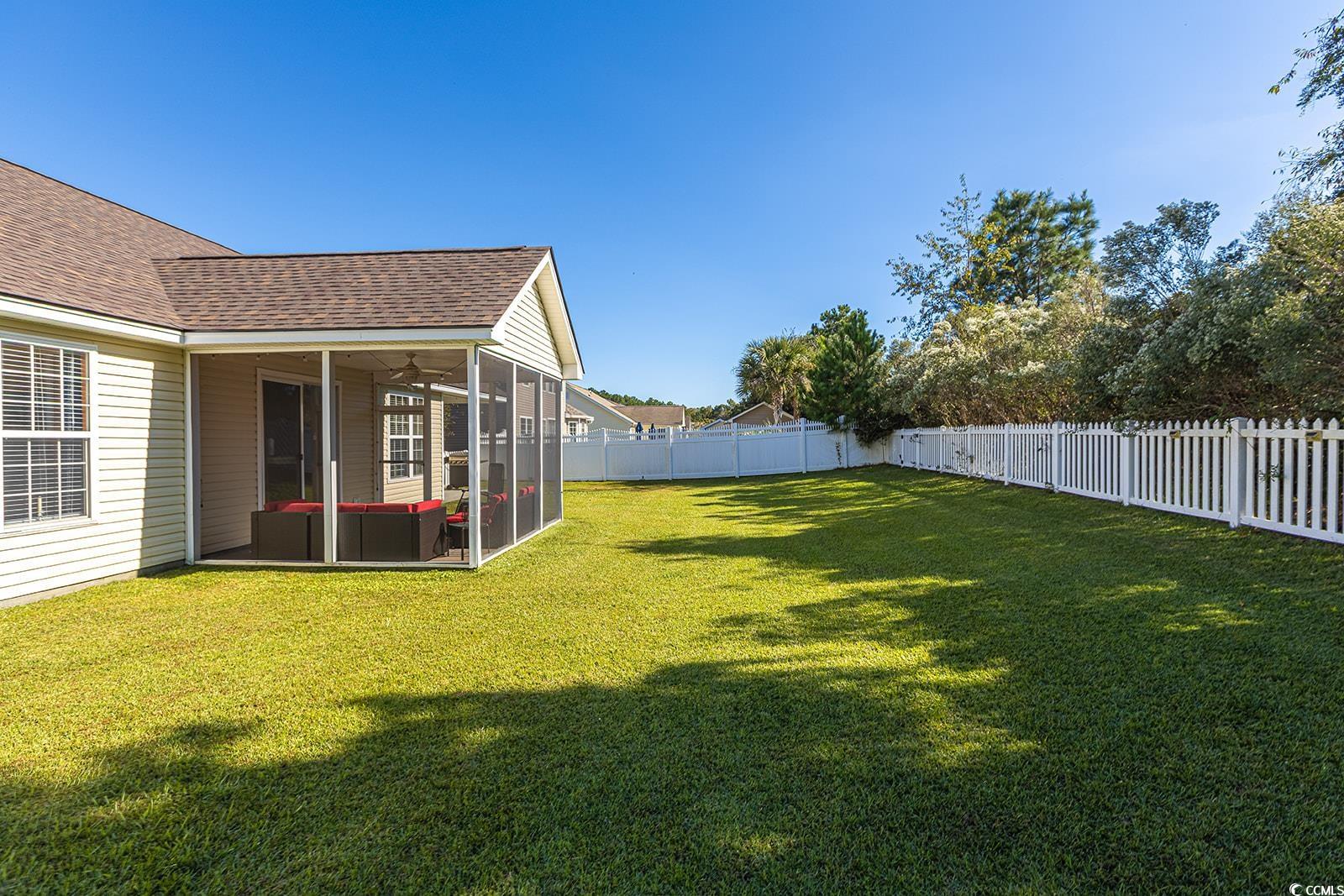 720 Gazania Lane Myrtle Beach, SC 29579 - Photo 26 of 32 Fenced backyard featuring a sunroom and a ceiling fan