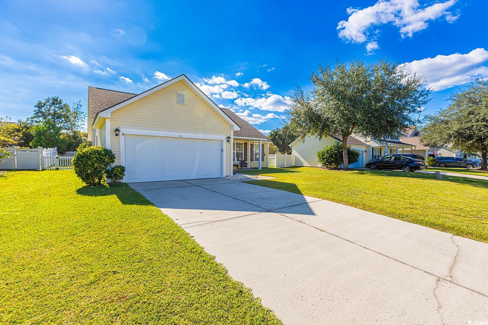 720 Gazania Lane Myrtle Beach, SC 29579 - Photo 29 of 32 View of front of home featuring a porch, driveway, a shingled roof, and a garage