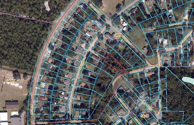 a green field with trees in the background