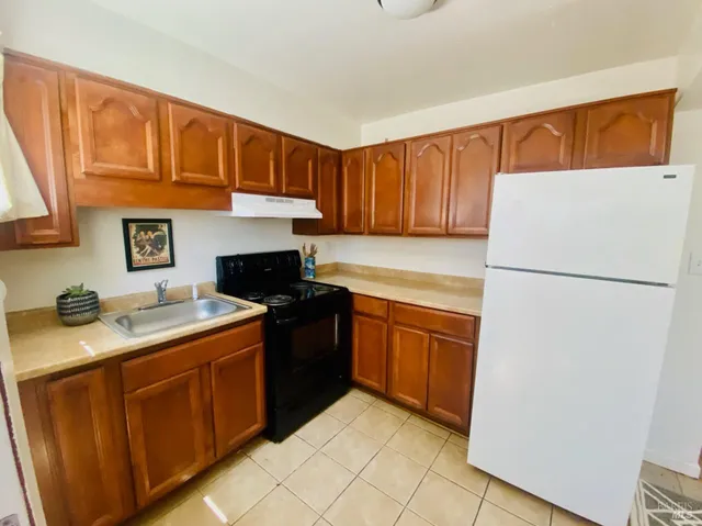 a kitchen with a refrigerator and a sink