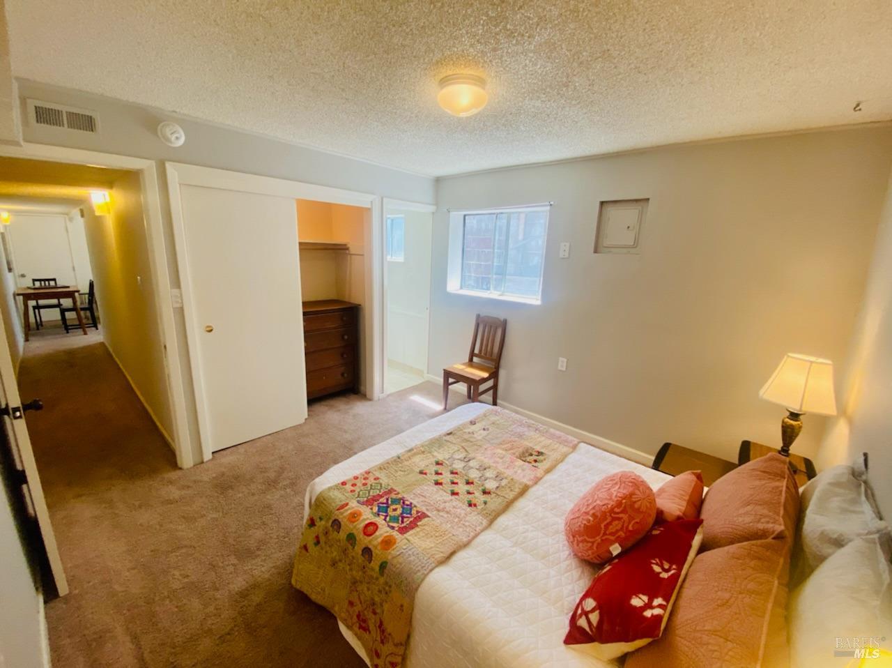 1722 Santa Clara Street, Unit LOWR Vallejo, CA 94590 - Photo 10 of 13 a bedroom with a bed and a chandelier