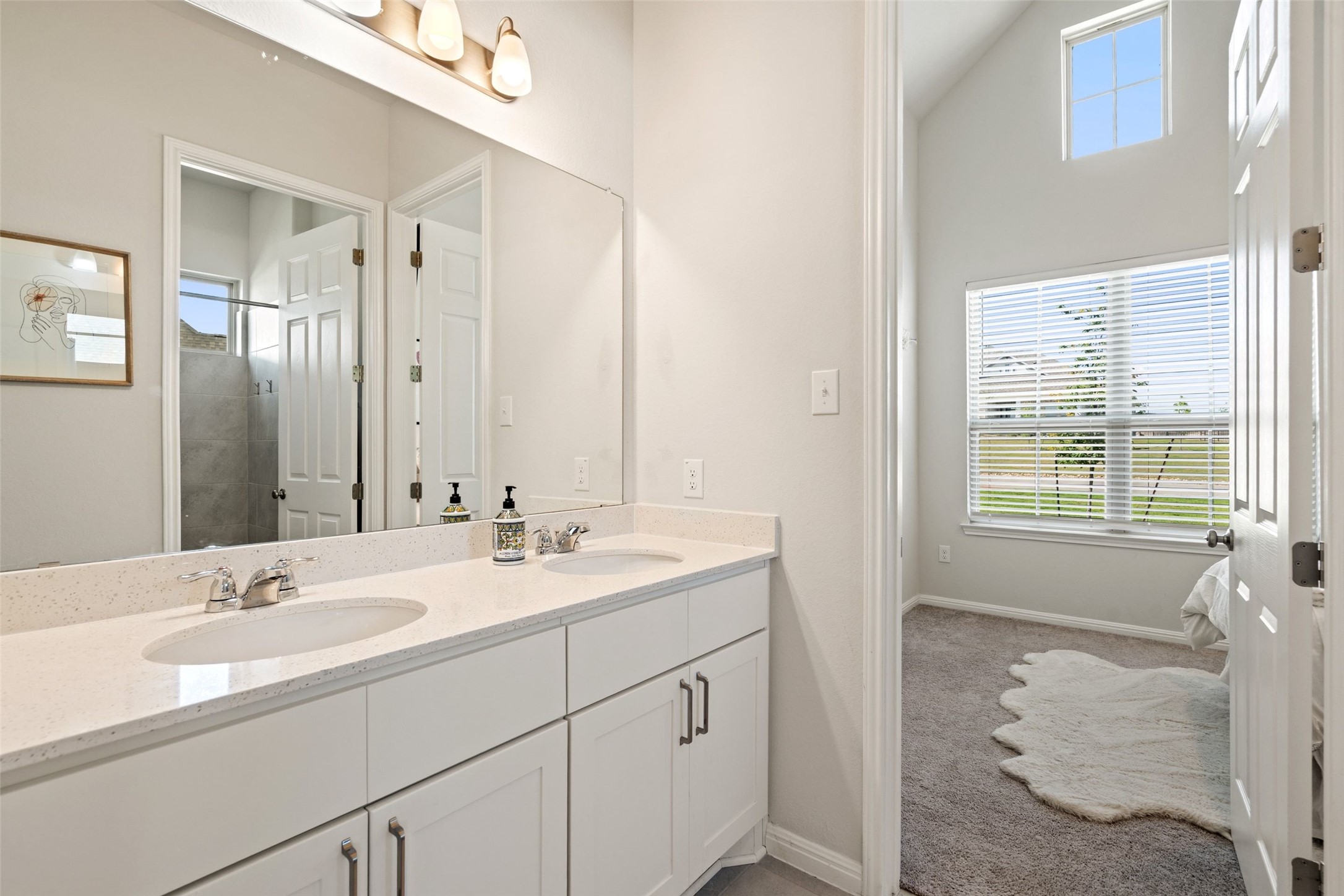162 Lunar Loop Austin, TX 78737 - Photo 23 of 40 a bathroom with a sink double vanity granite tub shower and a mirror