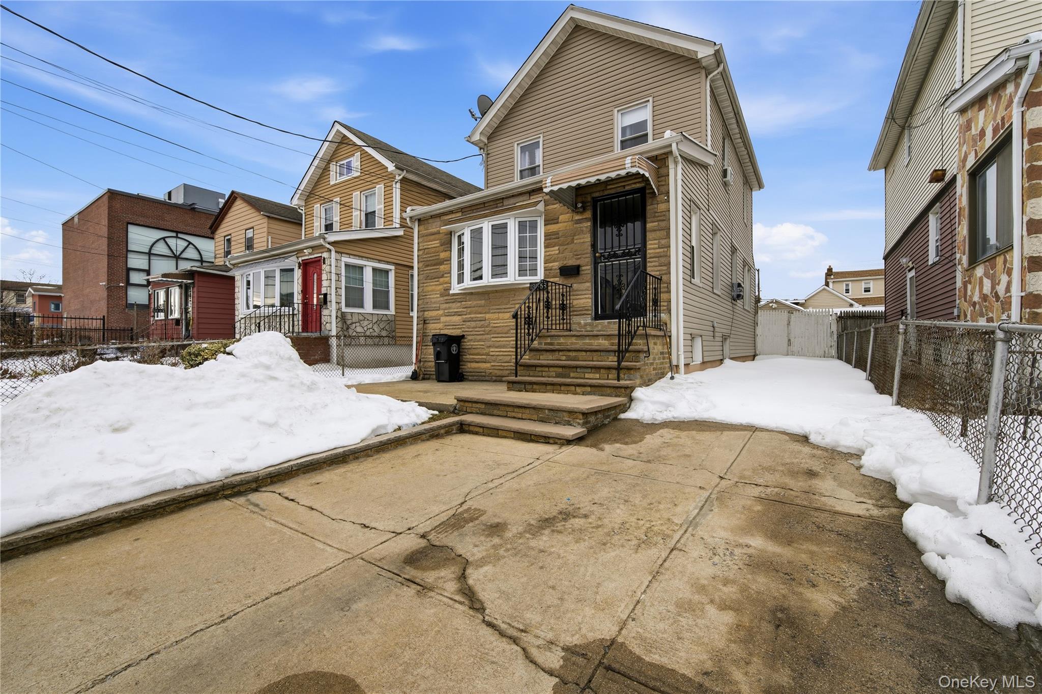 131-58 223rd Street Queens, NY 11413 - Photo 12 of 12 a view of a house with a snow in the yard