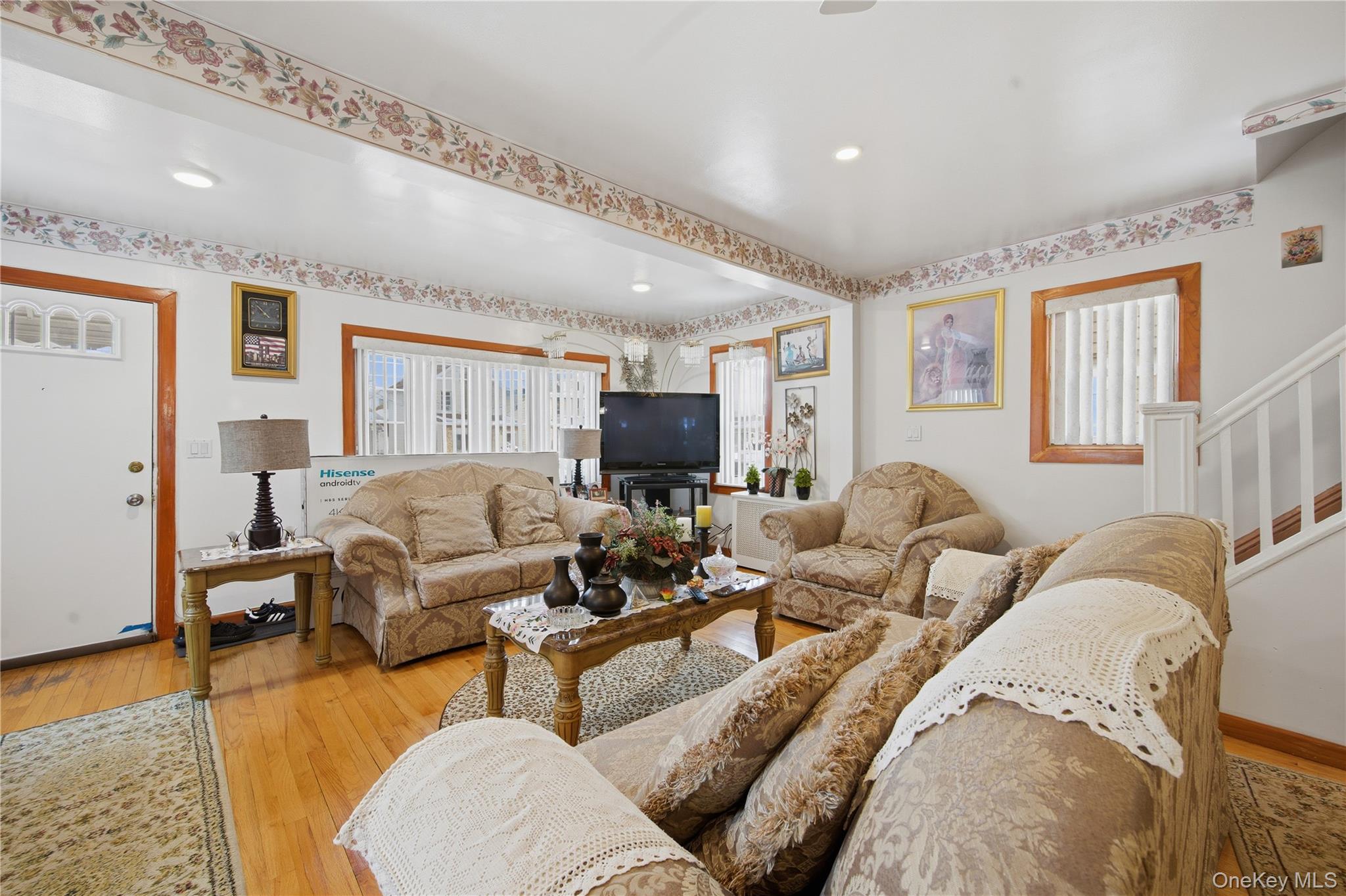 131-58 223rd Street Queens, NY 11413 - Photo 2 of 12 a living room with furniture and a flat screen tv