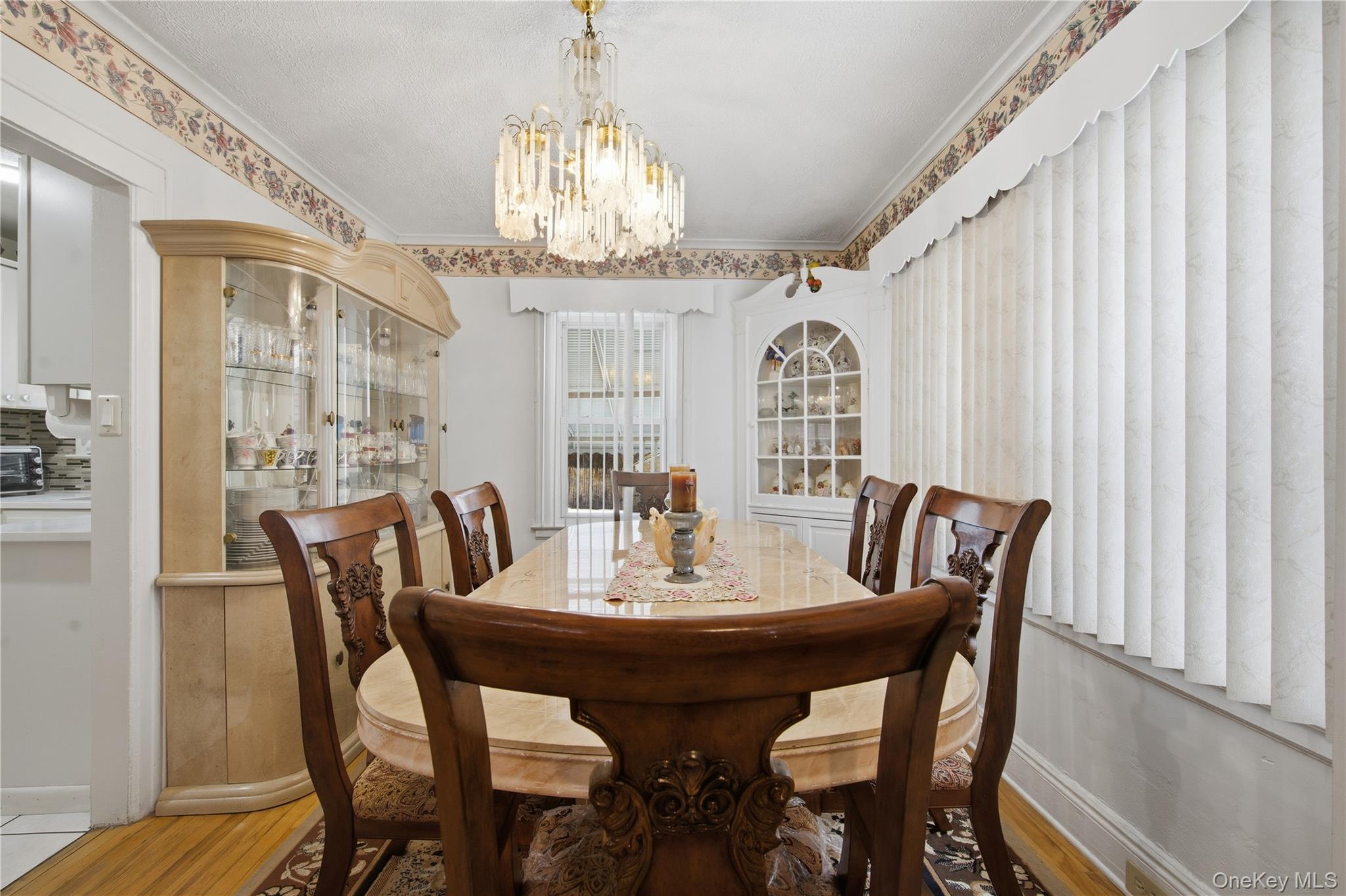 131-58 223rd Street Queens, NY 11413 - Photo 4 of 12 a view of a dining room with furniture window and wooden floor