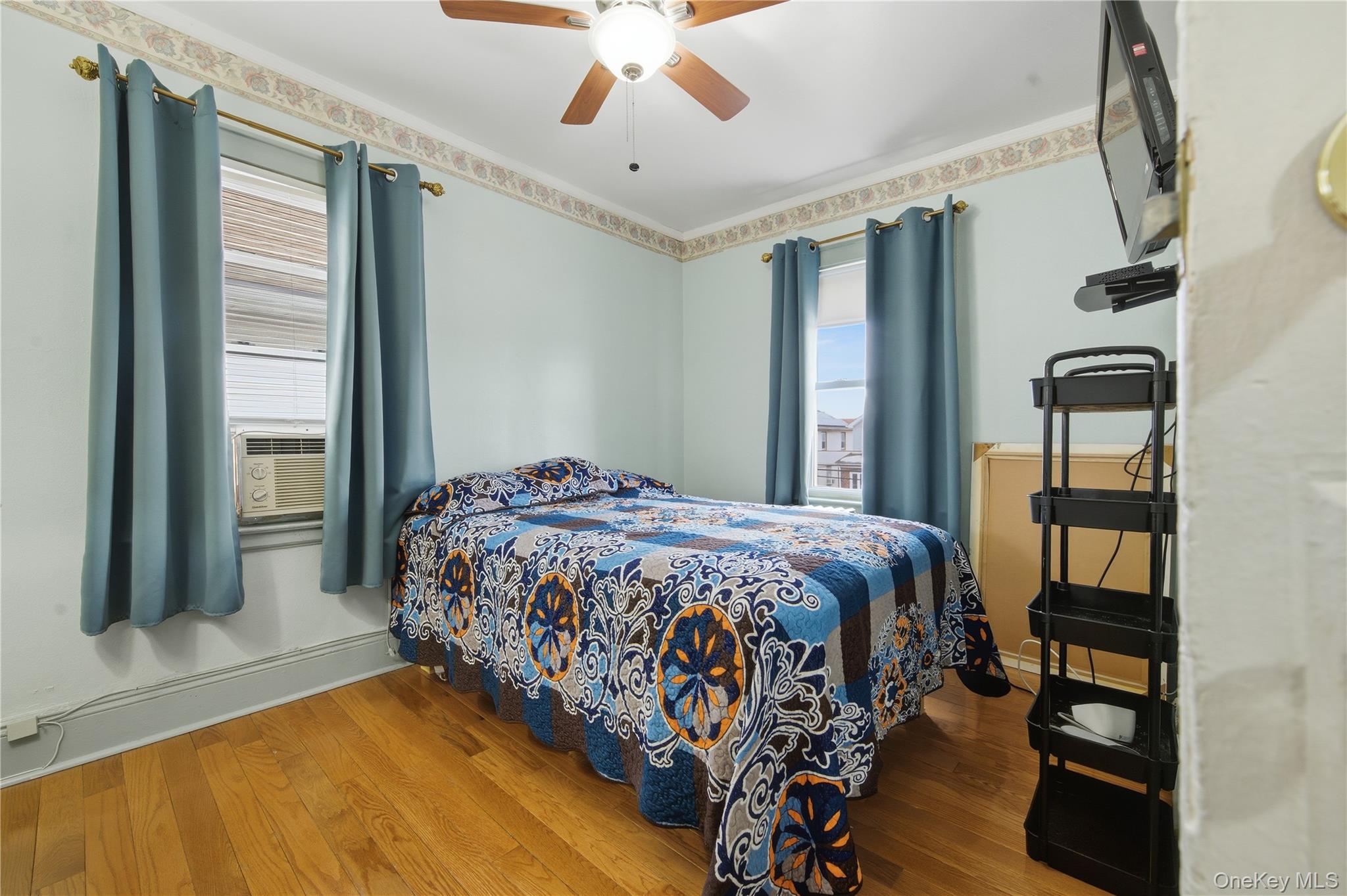 131-58 223rd Street Queens, NY 11413 - Photo 7 of 12 a bedroom with a large bed and a chandelier