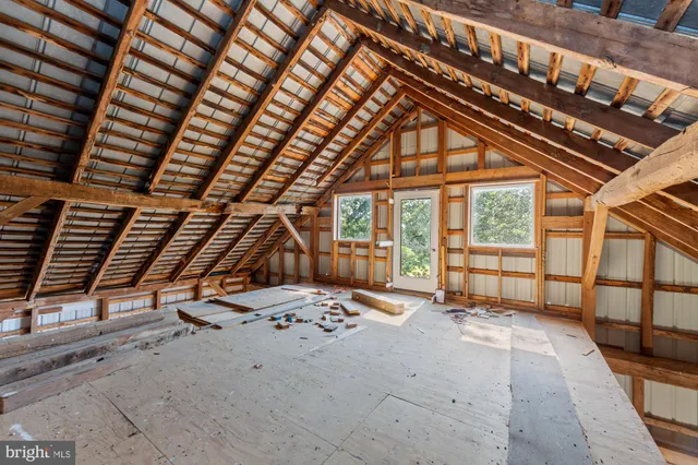 a living room with furniture a window and a clock