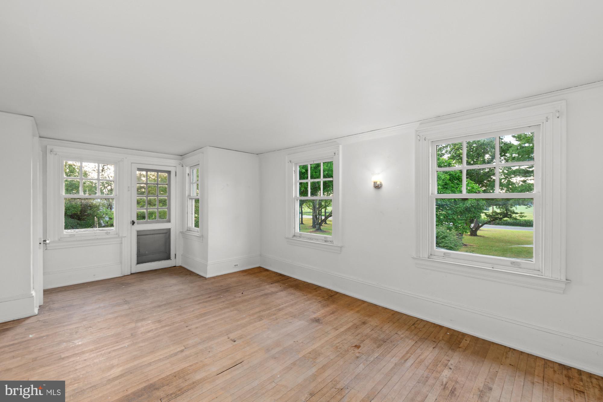 27058 Mt Pleasant Road Columbus, NJ 08022 - Photo 57 of 127 a view of an empty room with wooden floor and windows