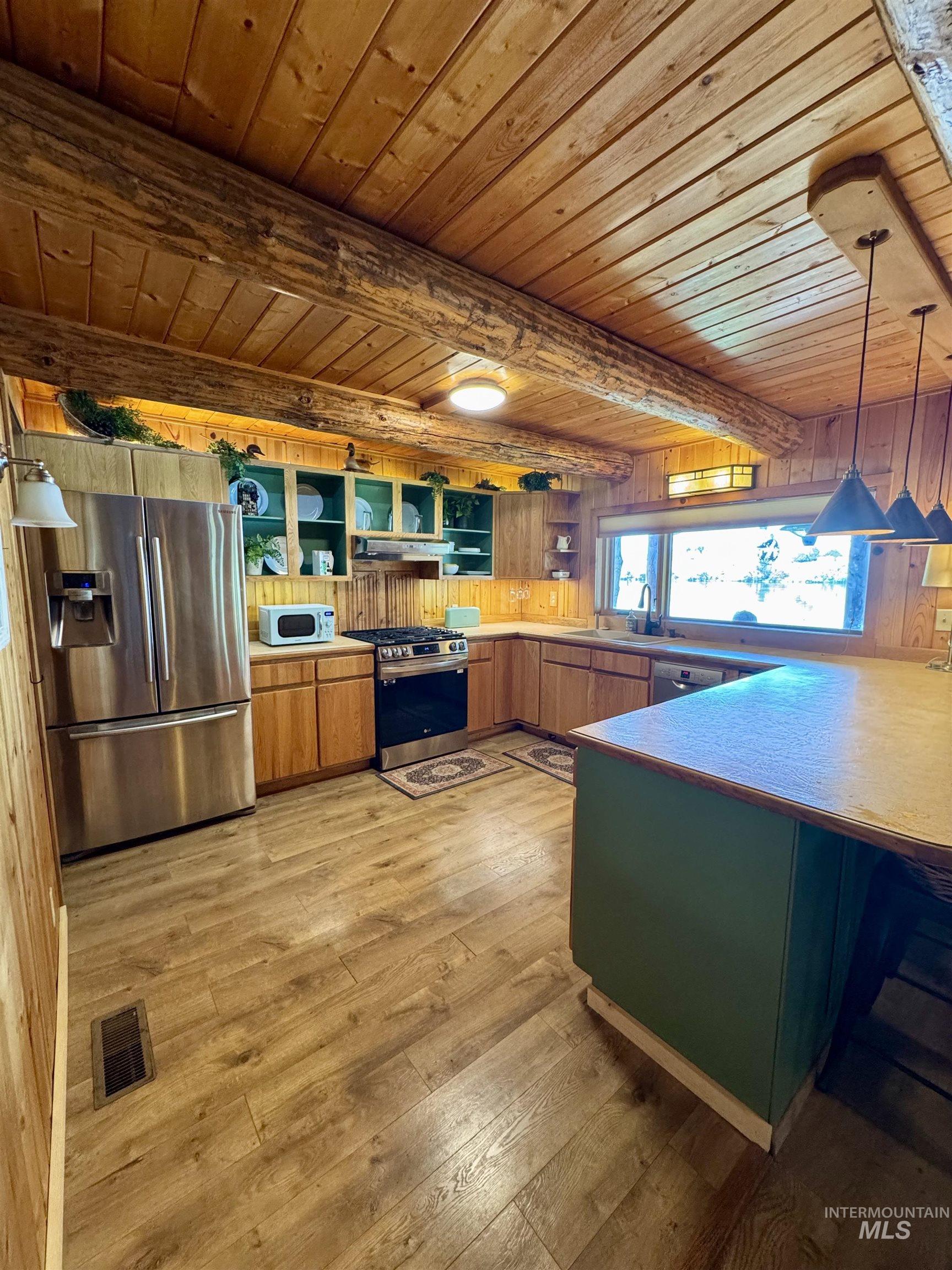 62 Bell Rapids Road Hagerman, ID 83332 - Photo 13 of 34 Kitchen featuring wood-finish flooring, natural wood cabinetry, stainless steel appliances, and a prominent kitchen island with a wood countertop