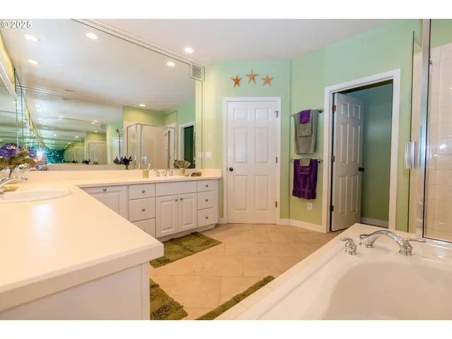 a bedroom with a bed and a large mirror