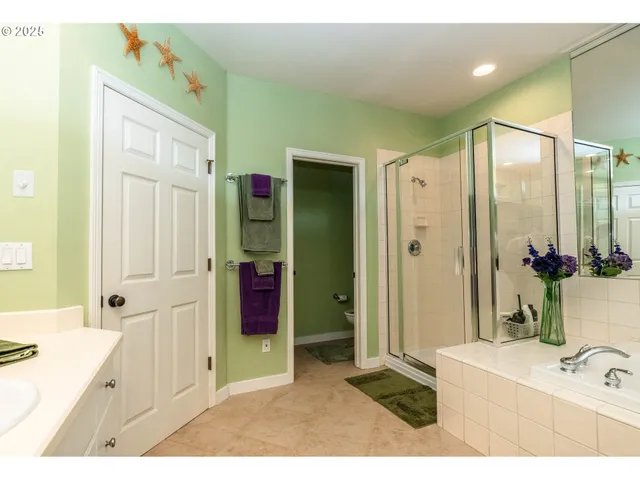 a bathroom with a tub sink and mirror