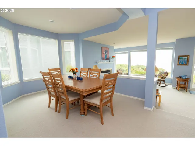 a view of a dining room with furniture and a window