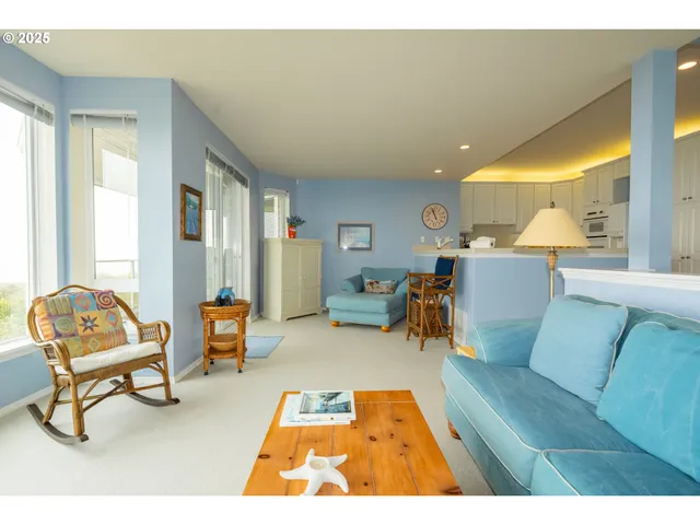 a living room with furniture and a dining table