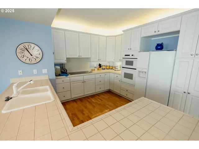 a kitchen with a sink cabinets and a window