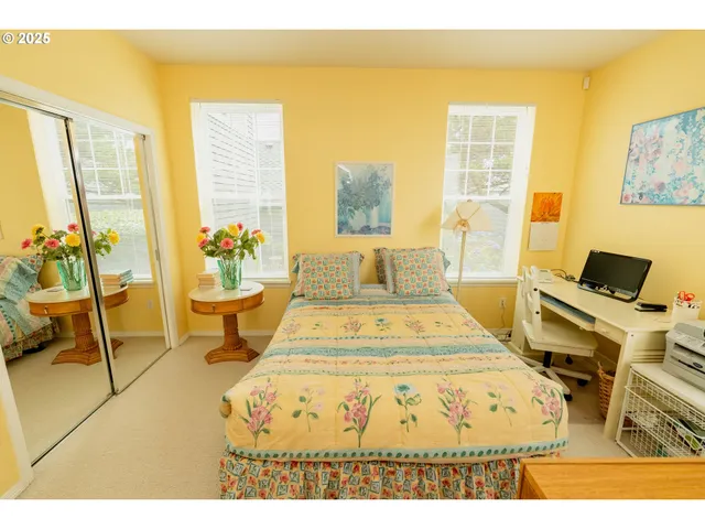 a living room with a couch and a potted plant
