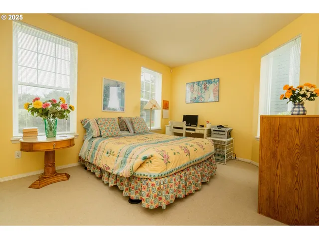 a spacious bedroom with a bed and a table