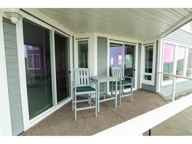 a porch with a table and chairs