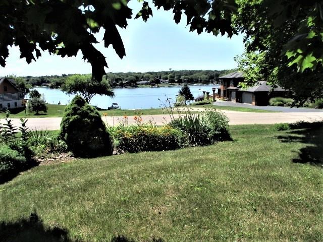 954 Winborne Road Lake Summerset, IL 61019 - Photo 2 of 26 a big yard with lots of green space and fountain