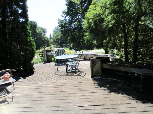 954 Winborne Road Lake Summerset, IL 61019 - Photo 10 of 26 a roof deck view with table and chairs plants and trees