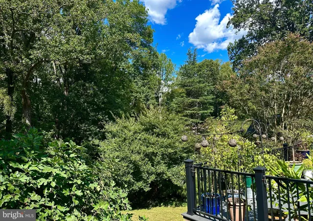 a view of yard from deck with patio