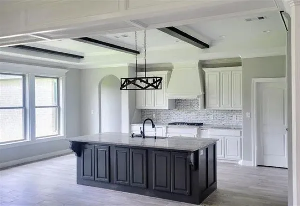 a kitchen with granite countertop a sink cabinets and window