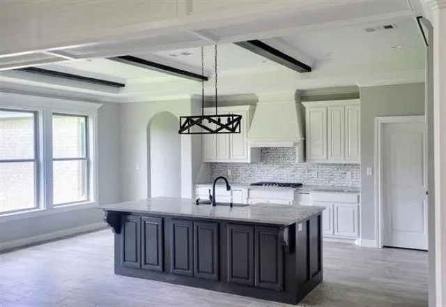 a kitchen with granite countertop a sink cabinets and window