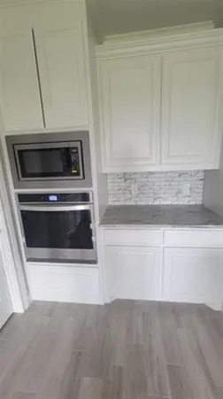 a close view of stove top oven and cabinets