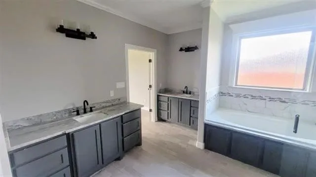 a bathroom with a tub sink and mirror