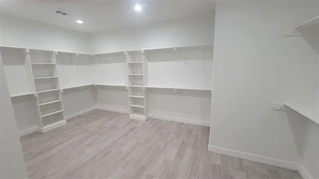 a view of a room with wooden floor and closet