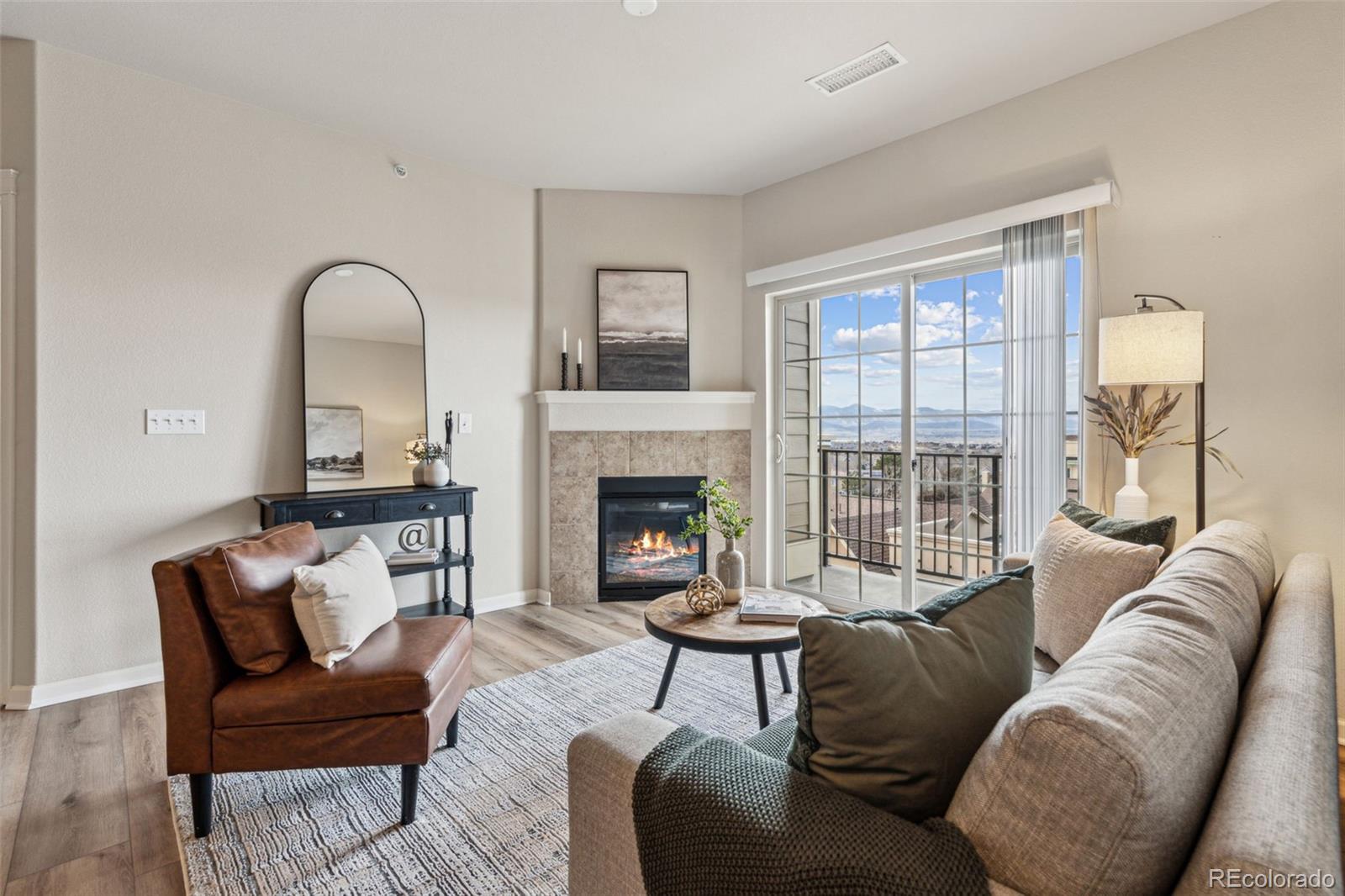 1062 Rockhurst Drive, Unit 401 Highlands Ranch, CO 80129 - Photo 1 of 41 a living room with furniture and a fireplace