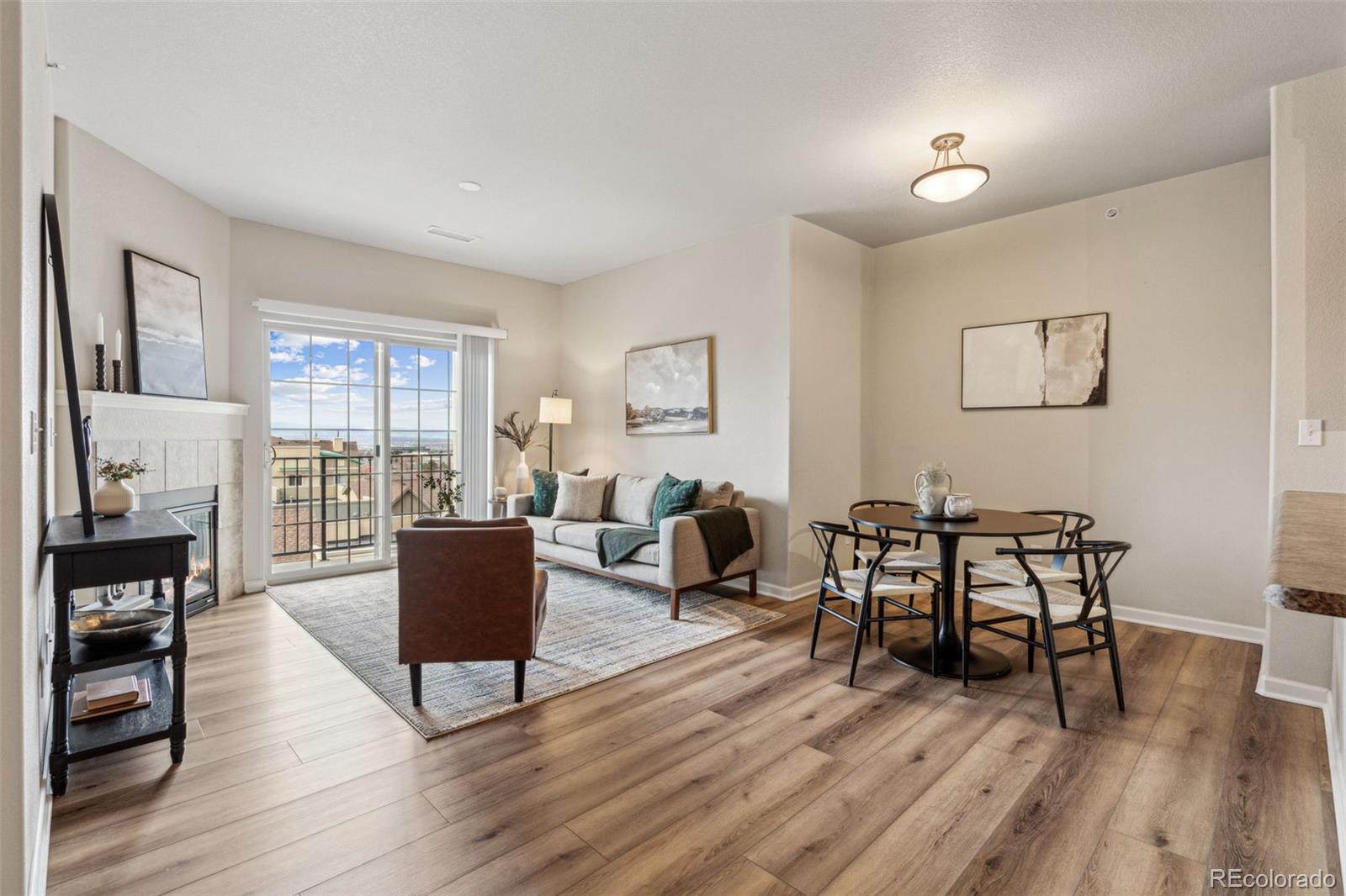 1062 Rockhurst Drive, Unit 401 Highlands Ranch, CO 80129 - Photo 14 of 41 a living room with furniture a dining table and wooden floor