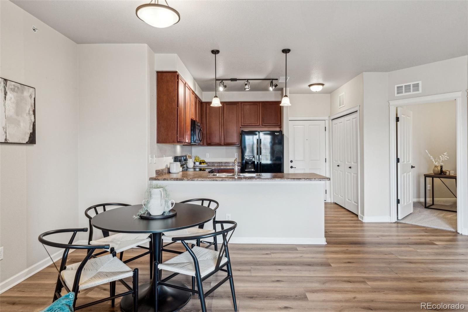 1062 Rockhurst Drive, Unit 401 Highlands Ranch, CO 80129 - Photo 19 of 41 a kitchen with granite countertop white cabinets and stainless steel appliances