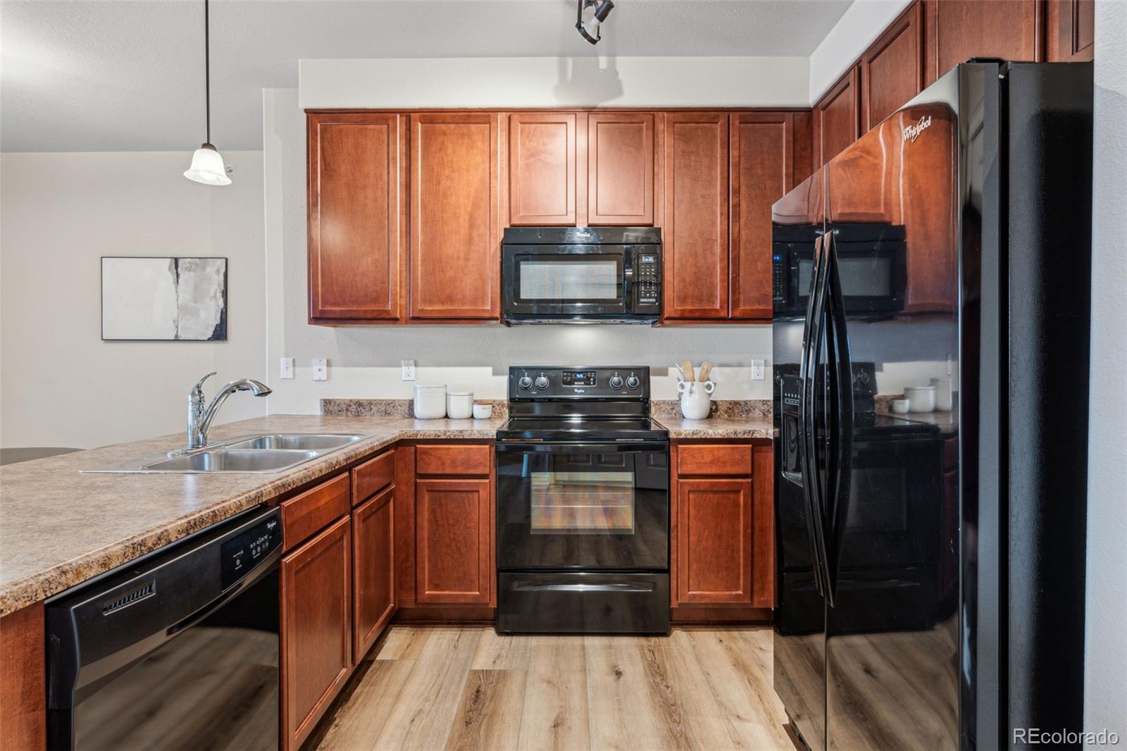 1062 Rockhurst Drive, Unit 401 Highlands Ranch, CO 80129 - Photo 20 of 41 a kitchen with stainless steel appliances granite countertop a refrigerator and a sink