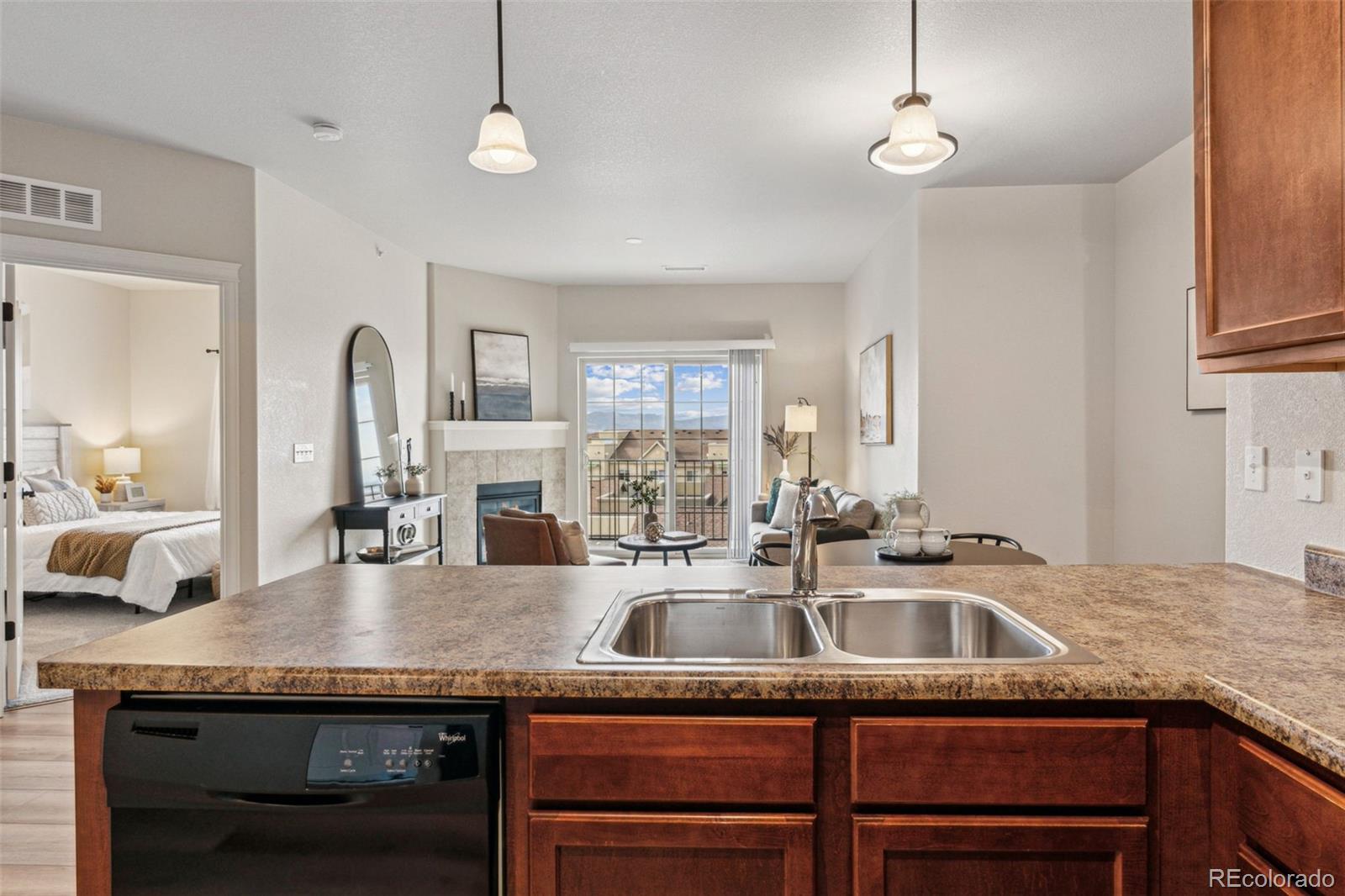 1062 Rockhurst Drive, Unit 401 Highlands Ranch, CO 80129 - Photo 21 of 41 a kitchen with granite countertop stainless steel appliances a sink and cabinets