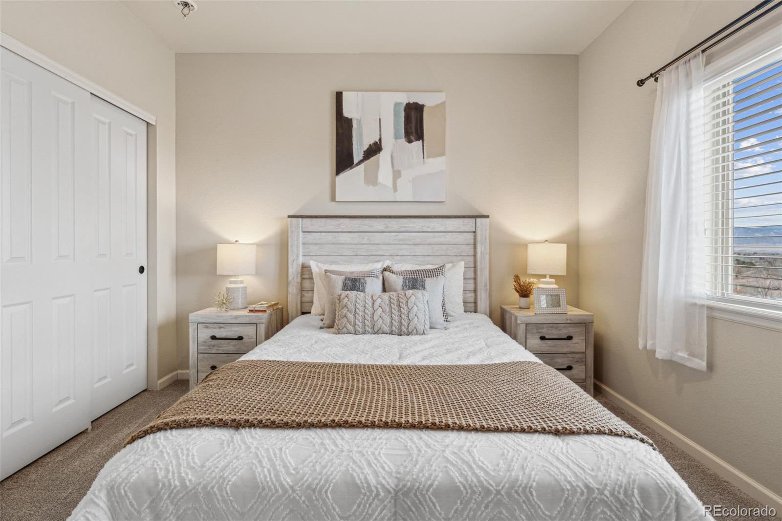 1062 Rockhurst Drive, Unit 401 Highlands Ranch, CO 80129 - Photo 23 of 41 a bedroom with a bed and a window